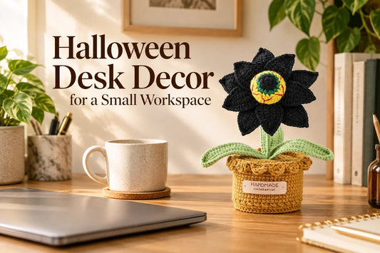 Halloween Desk Decor for a Small Workspace — Black crochet eyeball flower in a small pot on a clear wood desk