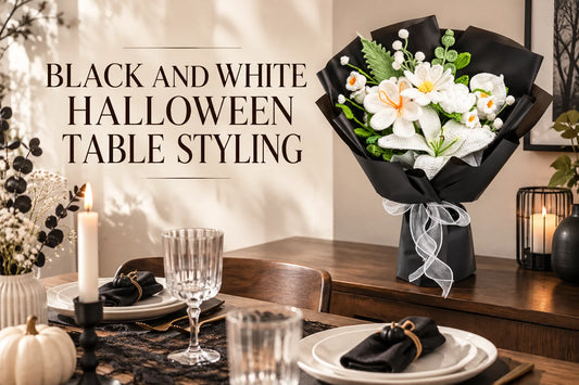 Black and White Halloween Table Styling — White crochet bouquet in black wrapping beside a black and white table setting
