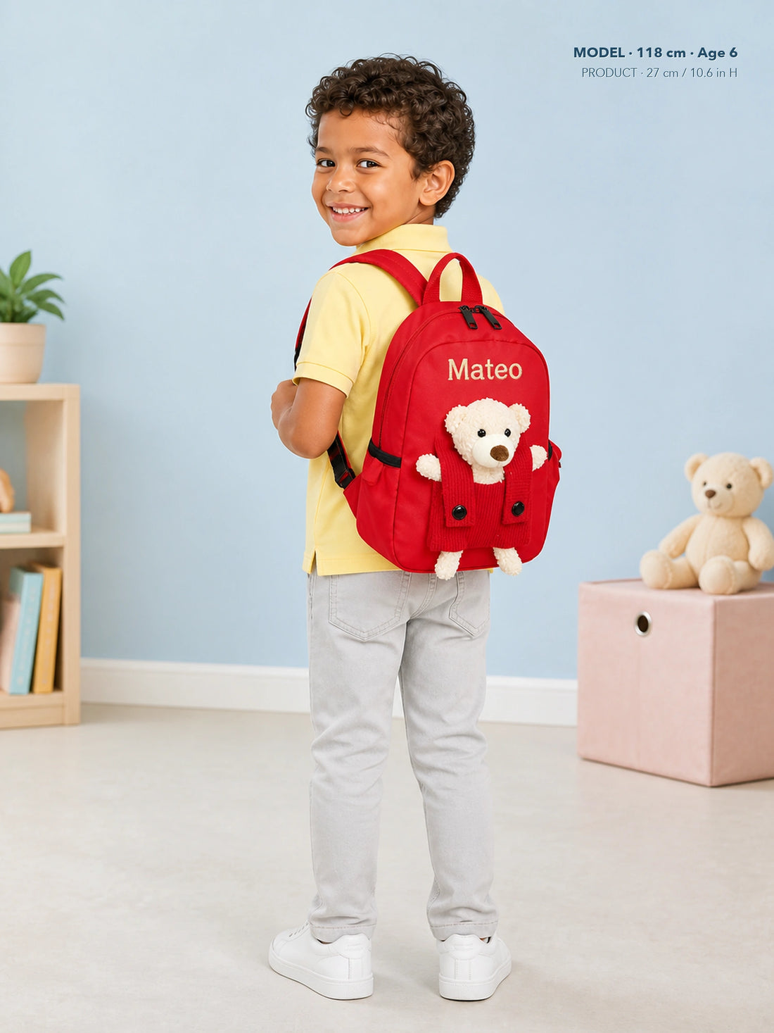 Child wearing red teddy bear backpack personalized with the name Mateo