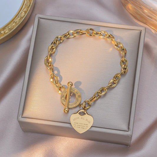 Heart pendant bracelet with an OT buckle on a chain-link band