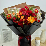 Crochet bouquet of 18 red and orange flowers in black wrapping
