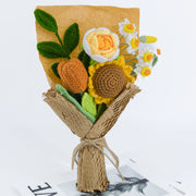 Crochet sunflower and daffodil bouquet in brown and yellow, wrapped in kraft paper