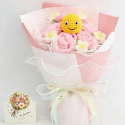 Round crochet bouquet of pink and white roses with an emoji face