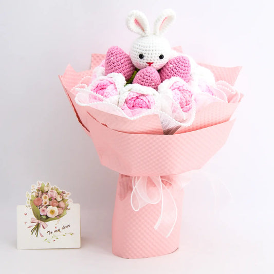 Crochet bouquet with a white bunny ringed by strawberries and roses