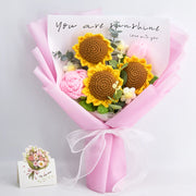 Crochet sunflower, rose and tulip bouquet in pink wrapping