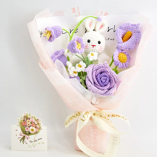 Crochet bouquet with a bunny among cup-shaped roses and calla lilies