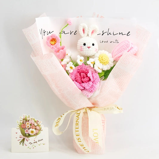 Pink crochet bouquet with a crochet bunny among roses, tulips and daisies