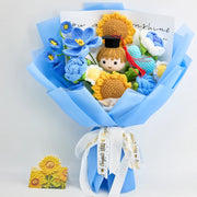 Blue and yellow crochet graduation bouquet with a graduate doll in a cap