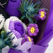 Close-up of purple lily-of-the-valley flowers and purple-and-white tulip with blue artificial greenery