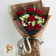 Crochet bouquet of dark red roses with dark wrapping