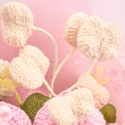 Close-up of cream crochet heart-shaped accents against pink wrapping