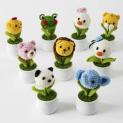 Crochet animal head potted plant in a white pot with green leaves