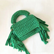 Green crochet handbag with tassels on both sides and a chain strap