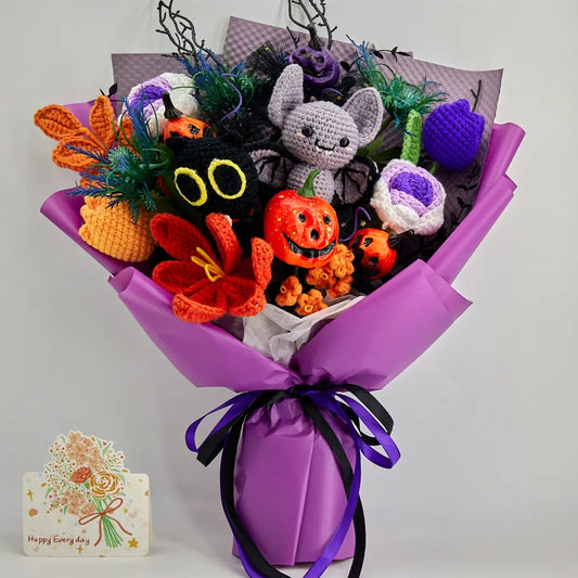 Full front view of the purple Halloween bouquet with gray crochet bat, black cat face, pumpkins and colorful flowers
