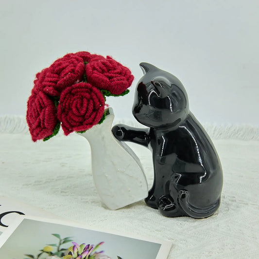Six crochet red roses with a black and white cat vase