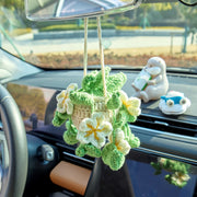White crochet car hanging with flowers and leaves