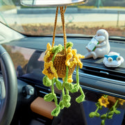 Crochet car hanging with several sunflowers and green leaves