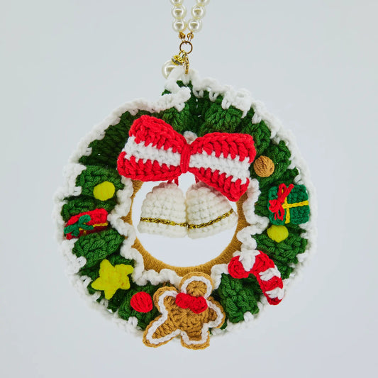 Crochet Christmas wreath with gingerbread man, candy cane, gift box and bell