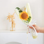 Small handheld crochet bouquet with a sunflower, calla lily and eucalyptus leaf
