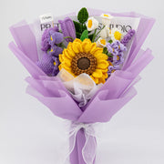 Full purple-wrapped crochet bouquet with large yellow-and-brown sunflower, purple rose and tulip, white flowers, lavender, and green leaves