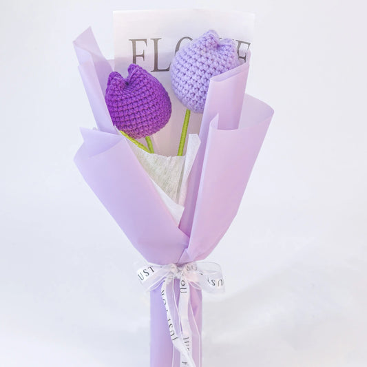 Handheld crochet bouquet of two closed purple tulips