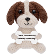 Crochet emotional support dog holding a message card