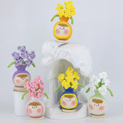 Vase-shaped crochet desk ornament with a pearl-tipped forget-me-not branch