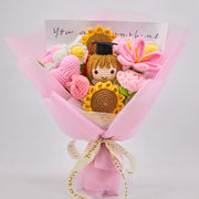 Pink and yellow crochet graduation bouquet with a graduate doll in a cap