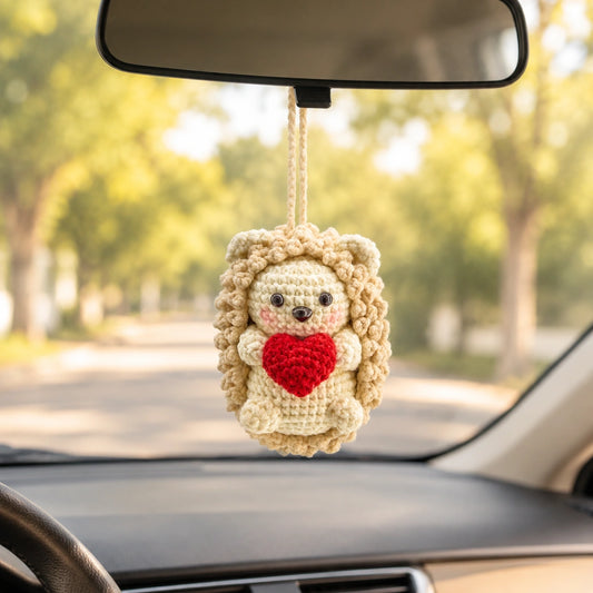 Crochet hedgehog car hanging holding a heart