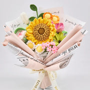 Crochet bouquet with an oversized sunflower, roses, tulips and daisies