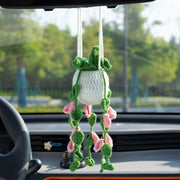Crochet car hanging with pink flowers in a white pot