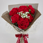 Crochet red rose bouquet wrapped in dark linen
