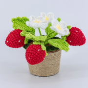 Crochet potted strawberry plant with three strawberries, three daisies and four leaves
