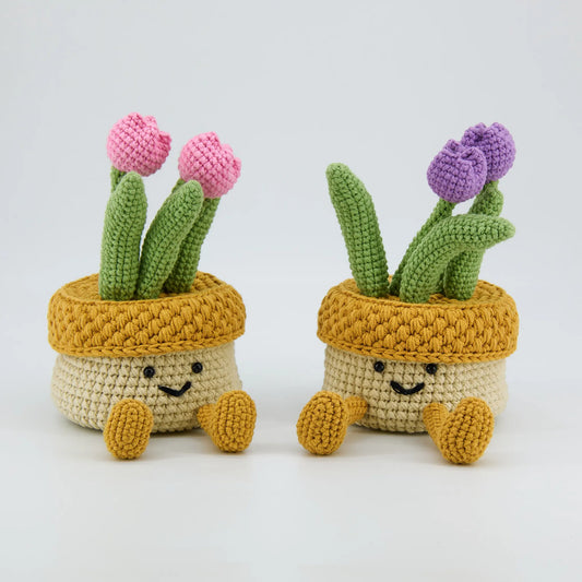 Crochet storage box with a removable lid topped by two crochet tulips