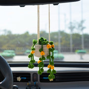 Crochet hanging pot with six branches of green leaves and yellow flowers